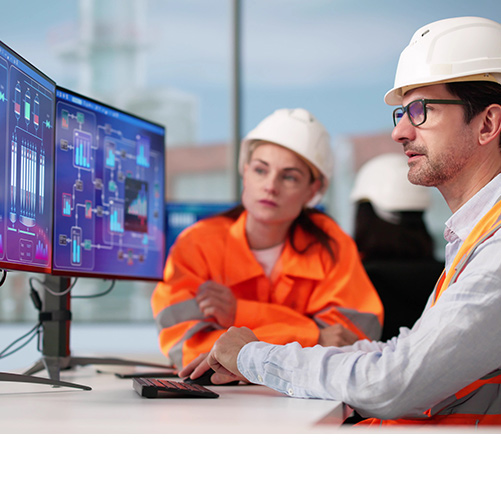 Industrial professionals analyzing process data on screen in an industrial environment