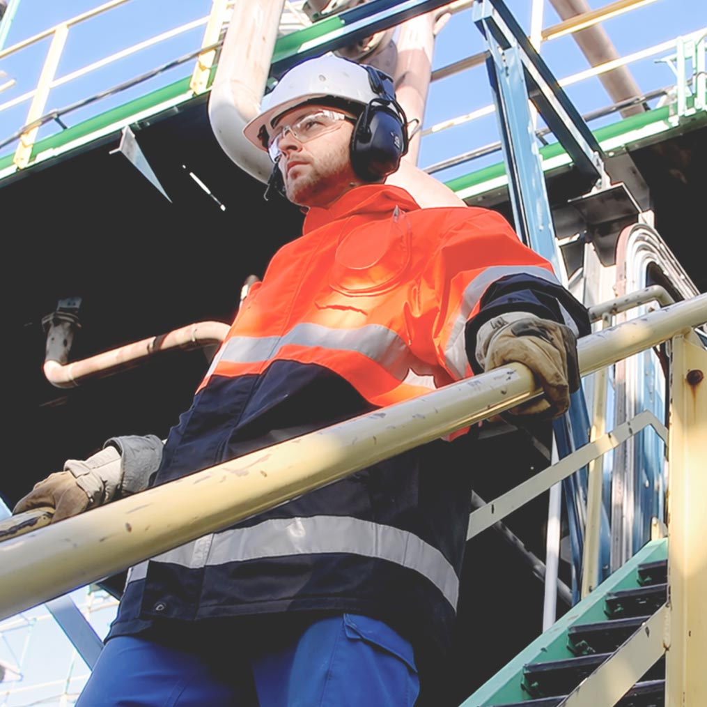 Industrial worker in protective equipment operating on a certified industrial facility