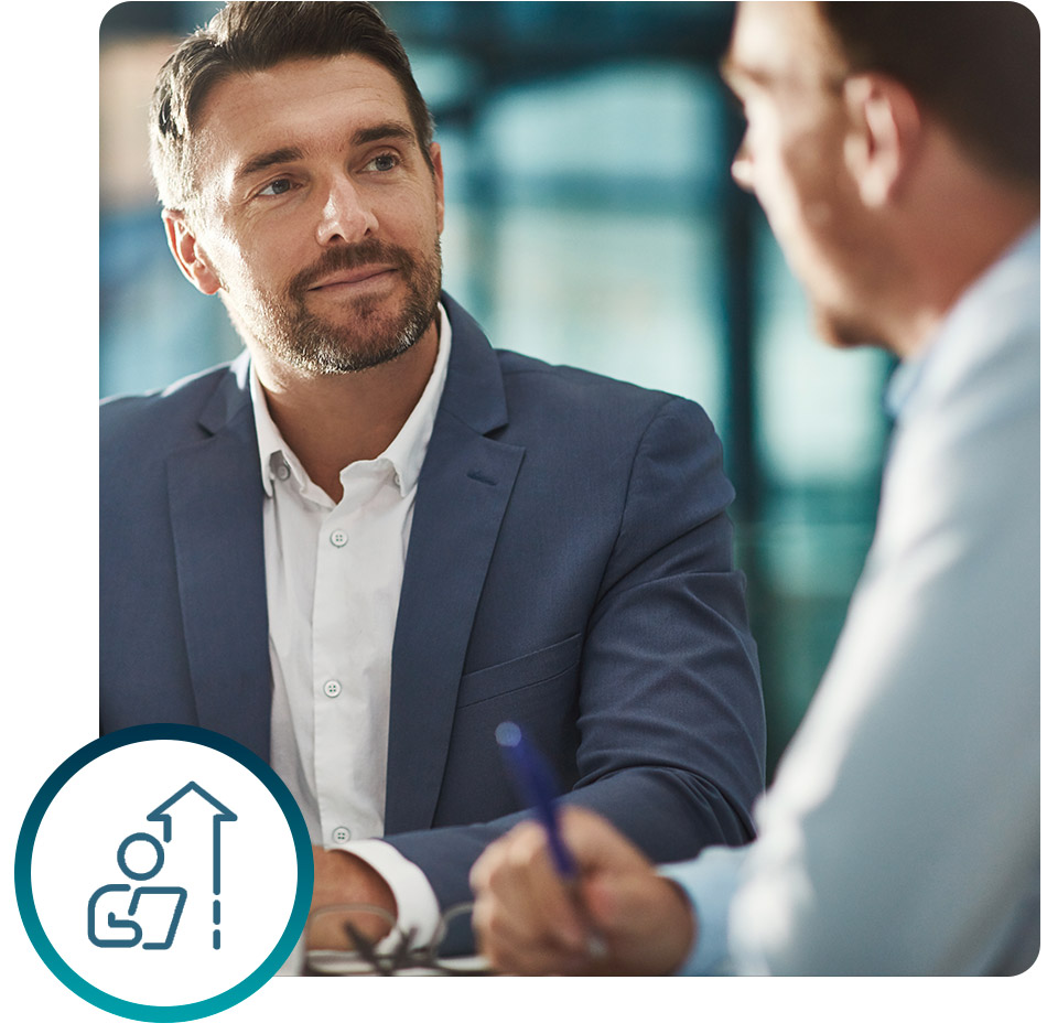 Two professionals in a meeting discussing skills analysis and organizational strategy