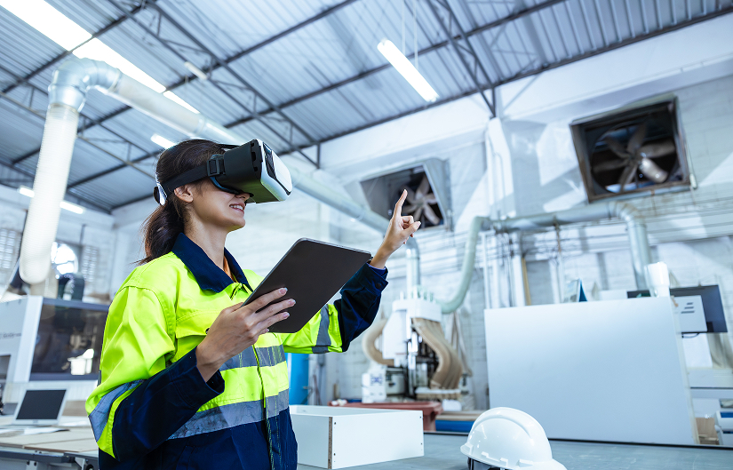 Learner using a virtual reality headset in an industrial environment to illustrate gamification and immersive learning technologies